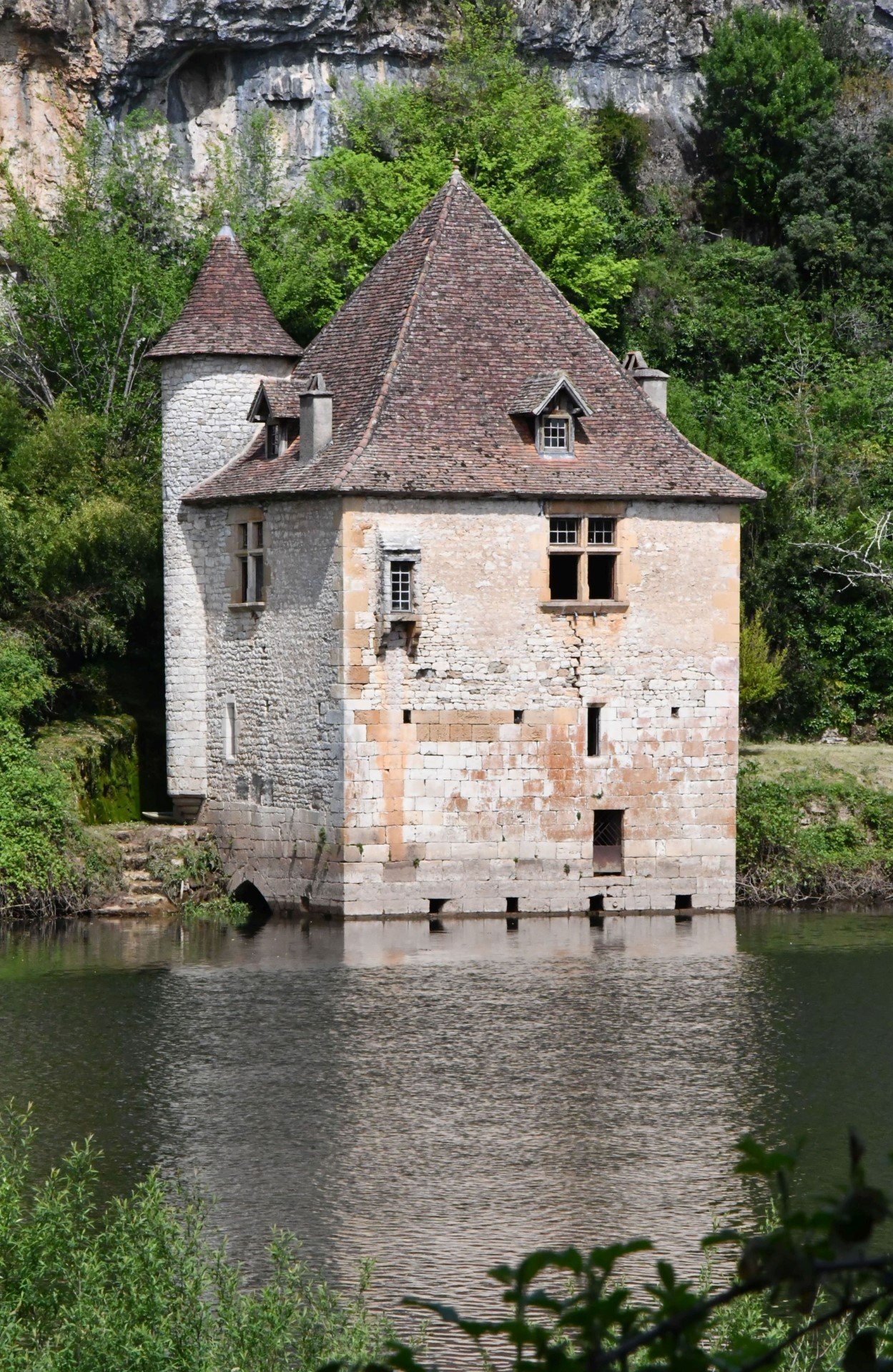 viewing across the river, framed by the branches of a tree, you see a stone mill, what would you like to do next?