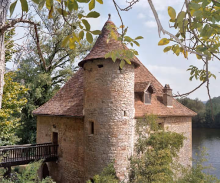 you are level with the roof on ancient square stone mill and nearest to you is a turret in one corner of the mill